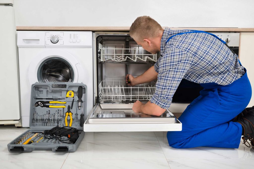 technician fixing a dishwasher repair charleston