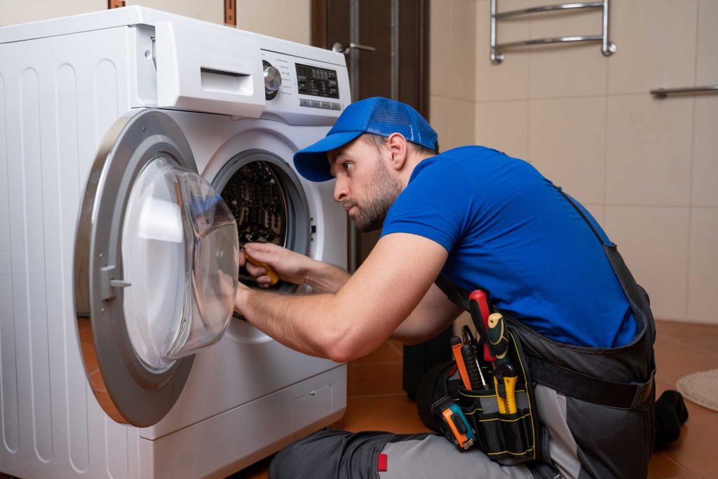 a technician repairing a washer and dryer repair charleston